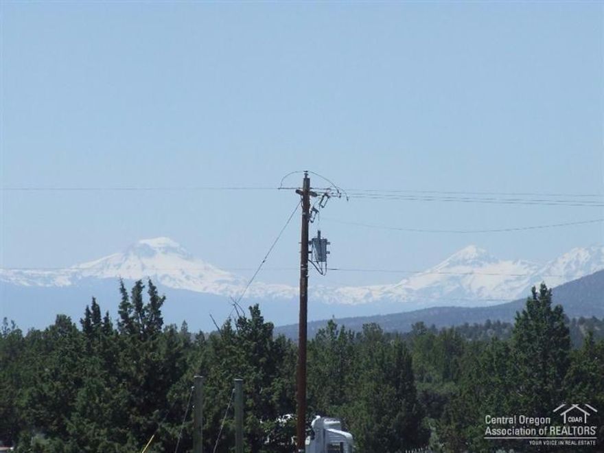 Beautiful Cascade Mountain Views from this fully fenced and gated 1.86 acre parcel on paved road. Level lot with a driveway, culvert power on 2 sides, standard septic already approved. Also a shipping container for you to store your belongings while building your dream home.
