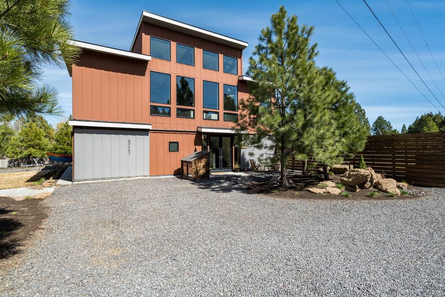 Stunning, modern, turn-key residence with custom cedar fence located on .5 Acre in a peaceful desirable neighborhood. Highlights include exposed beams, vaulted ceilings, open floor plan, and natural light throughout. Enjoy peekaboo views of cascade mountains, tree tops, dark skies, and bright stars from the panoramic windows that invite nature into your home. View the constellations while you stay cozy with your Lopi woodstove. Home features 2 bedrooms with spacious en suite bathrooms (master/walk-in closet) concrete counter tops throughout, SS appliances, concrete hearth pad, office space, tiled showers, custom wood work ascents, polished concrete floors on main, Bali solar shades (motorized for upper windows), stylish wood ceiling fans, laundry room/art studio, guest suite on main w/full bath, partial kitchen, separate entrance and private driveway. Efficient heat pump, LED lights (inside and out) 7 house is wired for Ethernet.