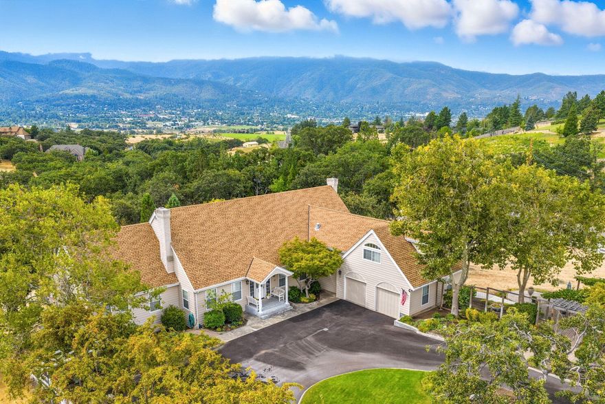 Incredibly desirable Ashland setting—private, quiet & close to town yet distinctly rural. On 5.09 acres with panoramic views of Mt. Ashland & the city, this 3566 sq ft 1985 home offers 5 bedrooms, 4.5 baths & two full primary suites, including a main-level retreat. The main floor features two sitting rooms with wood-burning fireplaces, a living room bar & a 2019 kitchen remodel with quartz leather-finish counters & painted cabinetry. Upstairs features two bedrooms with walk-in closets, a large bath & separate HVAC, plus a guest suite with a loft & window seat. Outdoor amenities: pool with Trex decking, gazebo, apple & plum trees, Gearky Creek, Talent Irrigation water & two workshops (50'x50' & 42'x36'). Other highlights: 2-car garage with workbench, wine cellar, auto generators, water softener, security system & abundant storage. Updates: roof, exterior paint, trellis, decking, railings, pool/spa (2018); HVAC (2019); blinds (2019); electrical/lighting (2018).