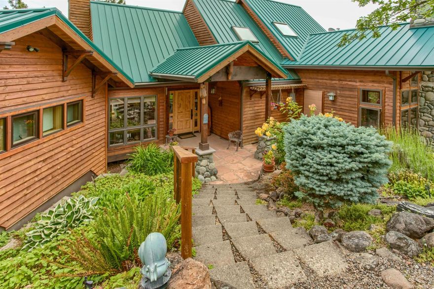Stunning Alpine style home with ultimate privacy yet close-in proximity to all Ashland has to offer. Quality materials throughout including exposed beams, Teak floors, an impressive two story river rock fireplace, Andersen wood windows & doors, decorative woods throughout & the list goes on. All the main living is on one level including a spacious master suite inclusive of it's own sitting area, fireplace & large windows overlooking trees, mountains & gorgeous valley views. Spa-like bathroom w/ gorgeous limestone and soothing soaking tub. Amazing walk-in closet. Versatile floorplan offers en suite bedrooms/bathrooms on each level plus and incredible office w/ expansive built-ins.This stunning property will please the most discriminating buyer. Chef's dream kitchen features commercial grade stainless appliances. Ample room for both indoor & outdoor entertaining. Expansive decks. Durable metal roof. Detached outbuilding/garage with work shop area. Gated driveway & 6 natural acres.
