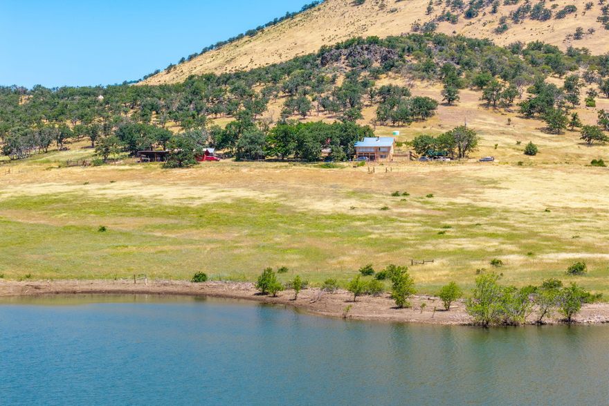 Experience serene lakefront living on over 43 breathtaking acres just 15 minutes from downtown Ashland. This rare horse property offers the perfect blend of natural beauty and modern convenience, with fenced pastures, rolling hills, dramatic rock outcrops, incredible lake and mountain views and complete privacy. Enjoy morning rides or peaceful walks in your own scenic sanctuary. The home features two spacious garages—ideal for vehicles, equipment, or workshop space. Whether you're an equestrian enthusiast, nature lover, or seeking a private retreat close to town, this one-of-a-kind property delivers unmatched lifestyle and opportunity.