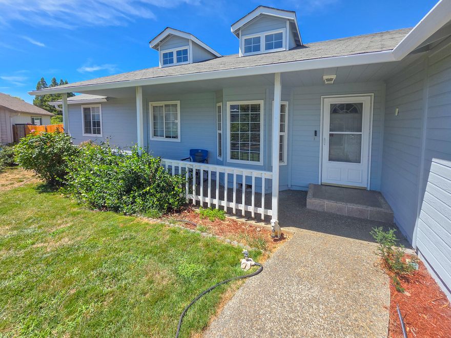 This 3-bedroom, 2-bath home is situated at the end of a cul-de-sac and features a living room with vaulted ceilings, a bay window, and skylights. The property also includes a formal dining area, a kitchen with a pantry and ample storage, a covered porch, and recent updates with fresh interior paint and new flooring. Its location offers convenience, being close to Reinhart & Riverside Parks, city services, and the Rogue River.