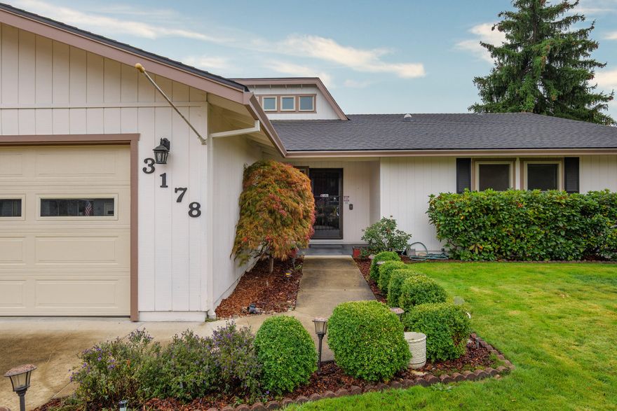 Fantastic East Medford location close to medical, shopping, and schools! This spacious 3-bedroom, 2-bathroom home sits on a large lot and includes a rare find — a 660 SF shop right in the heart of town. The kitchen features a breakfast bar that opens to a cozy living room with a fireplace, flowing seamlessly into the formal dining area and a second spacious living room. For plant lovers, the light-filled atrium is the perfect space to nurture your indoor garden. The primary suite offers two closets and dual sinks, with two additional bedrooms and a guest bath nearby. Step outside to a huge covered patio spanning the length of the home — ideal for entertaining — and a generous backyard with plenty of room to play, garden, or simply relax.