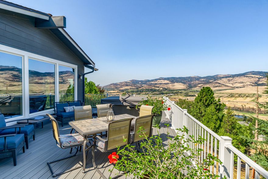 This stunning Ashland home has been beautifully remodeled and offers views, space and a versatile open floorplan. Main level owner suite features a beautifully tiled bathroom, spacious walk-in closet. There is another spacious bedroom with adjacent bath to create a secondary suite if desired. Open kitchen with custom cherry cabinets, tiled floors granite counters, gas range/oven and stunning expansive views. Light-filled and vaulted great room is a fabulous place for entertaining and leads directly to the newly constructed oversized deck, complete with hot-tub. Lower level has two additional bedrooms, a full bathroom and family room. It makes a great place for hanging out, home gym or even longer term guest. Two car attached garage, plentiful off street parking.