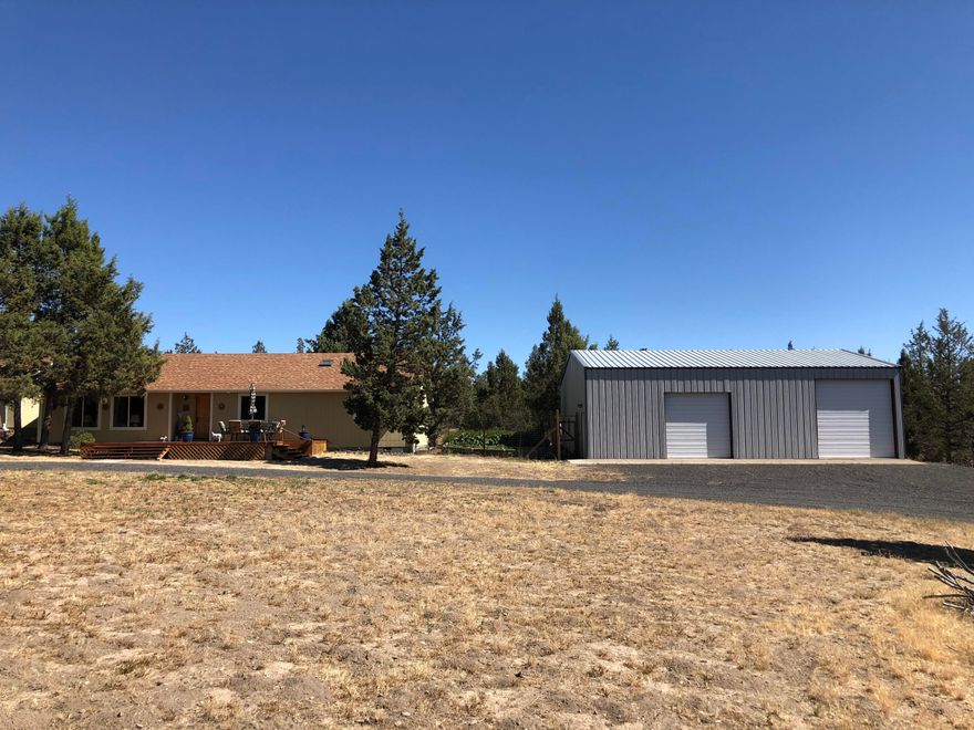 This 4.3 acre property boasts a 1,774 sf, 3 bed/2 bath home, a 1,728 sf shop and a 2 car detached garage with a work bench. The home features Pacific walnut hardwood floors, quartz countertops, convection oven with induction cooktop, custom hickory cabinets and a sun room that can also serve as a screened in porch area. The shop is fully insulated with an office and a loft, in addition to 220 power.  The fully fenced backyard includes 2 greenhouses, as well as raised garden beds with an automatic watering system. This property offers plenty of privacy and room for animals and is only 5 miles from Prineville Reservoir.