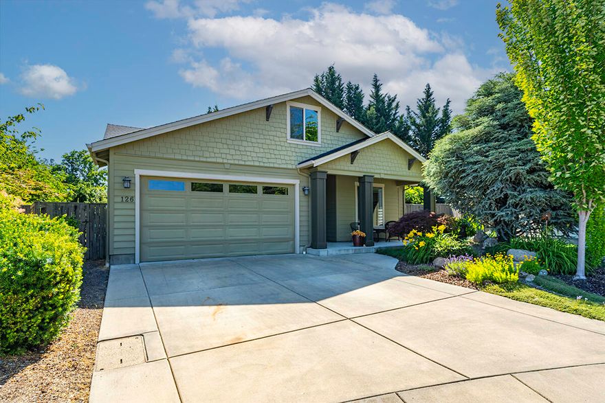 You will love this well-designed single-level built home, tucked away at the end of a quiet cul-de-sac in Talent, Oregon. This quaint & friendly town with eateries, coffee houses & live theater is a favorite of many, located just 4 miles from Ashland.  Built by Cota Homes for a family member, many special features & upgrades added including great room with vaulted ceilings & gas fireplace, smooth porcelain floors & granite kitchen with large dining bar & pantry.  Great split floor plan with lovely primary with upscale Travertine bathroom with dual sinks, stone shower & walk in closet & two additional bedrooms with full bath at opposite end of the home. French doors lead to private, lush rear yard with large, covered patio, second dining patio, mature trees & greenery, fruit orchard, expansive lawn area, planter beds & fully fenced. Nice laundry room with Travertine folding counter, attached garage with workshop area & pull-down storage in the attic. Great neighborhood, fabulous home!