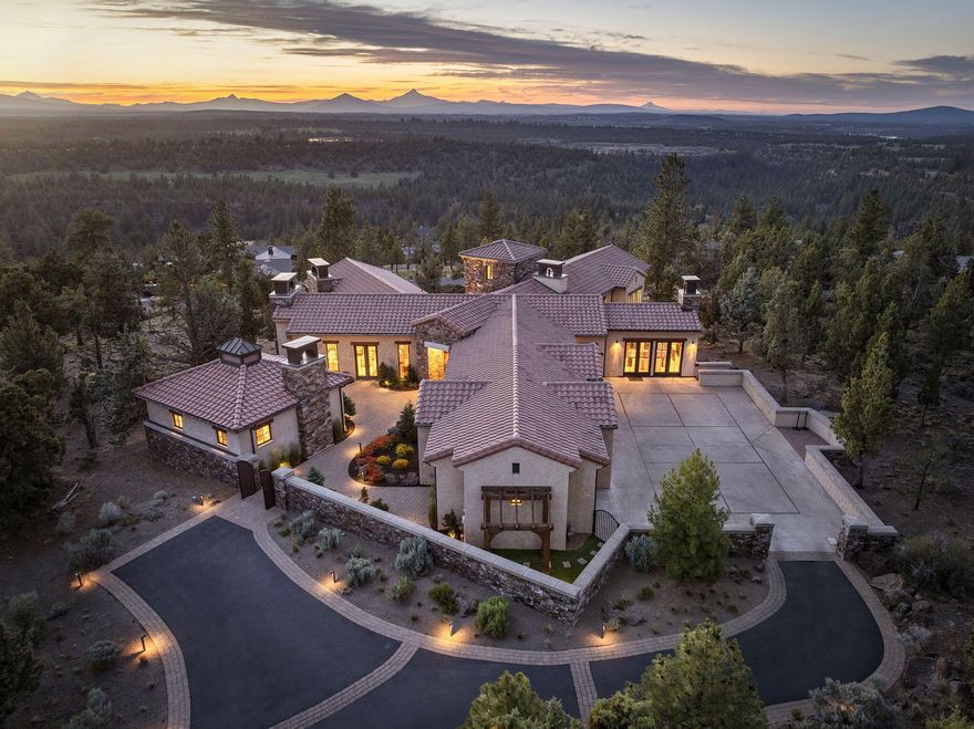 This stunning, completely remodeled North Rim home offers a grand total of 6,389 sqft of beautiful living space, including a separate 450 sqft casita. An additional 1,300 sqft was added to the main house during the thoughtful 2019 expansion, bringing the main home to 5,939 sqft. Iconic Cascade Mountain views span Mt. Bachelor to Mt. Hood. Multiple patios invite peaceful alpenglow mornings and unforgettable sunsets. The main-level primary suite is a private retreat with dual vanities, large walk-in closet, radiant heated floors, and a connected den. The kitchen features luxury appliances: two dishwashers, four ovens, sous vide, ice maker, oversized islands, and more. The lower level offers two ensuite bedrooms, a charming bunk alcove for four, and a wine cellar with prep sink. Outside enjoy your own private pickleball court, turf dog patch with drainage, tranquil water features, sports room, 3-car garage, and custom climbing wall.