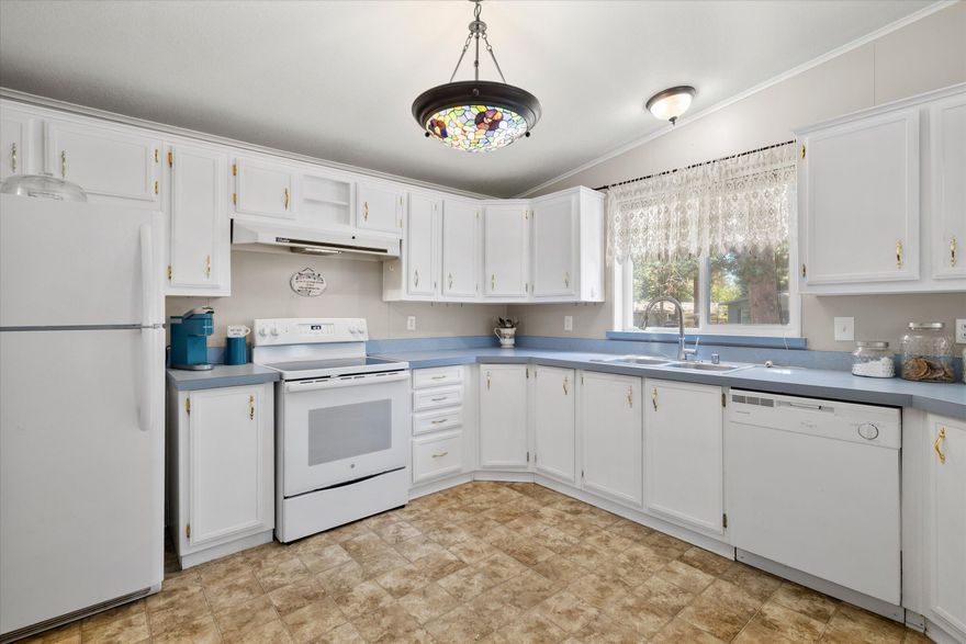 Tucked into the heart of Romaine Village, this move-in ready home offers comfort, privacy, and value in a convenient Bend location. Inside, you'll find an open floorplan with spacious bedrooms, full bathrooms, and fresh interior paint that gives everything a crisp, clean feel. Brand new carpet and a new stove add modern updates, and all appliances are included—just bring your toothbrush! Enjoy the comfort of A/C in the summer, plus the practicality of a covered carport and two outdoor storage sheds for all your gear. Out back, a newly built wood fence creates a private space to unwind or entertain. Come check out this gem that balances affordability with function and style!