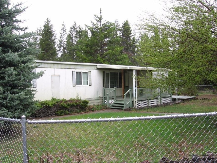 Well kept 2 bed/1 bath single wide manu w/covered front porch, mature landscaping. Oversized dbl car garage, cool top RV cover & storage container on an acre. Perfect for a rental property, vacation home, starter or retirement home.