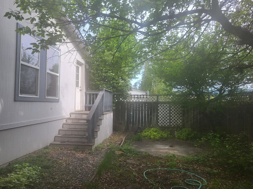 SUPER LOW SPACE RENT in small 
Grants Pass senior park.  HOME WARRANTY included in sale. OWNER CARRY with 75k down.  Large 3bd, 2ba, vaulted ceilings with open-floor plan.  Primary en-suite with office, 6 month old mini-split AC/Heat also heatpump, washer and dryer included in full laundry room, 5 yr old Regency wood stove in living room and large 12x16 stick-blt shop with extra long 3-car carport.  Fully fenced backyard for pets and lush landscaping all with great location off Redwood Ave near all services and medical.