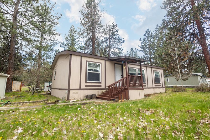 Come check out this 3 bed 2 bath manufactured home in a well established neighborhood in Southwest Bend! Double wide home on a wide corner lot with matured landscaping all around. Open concept kitchen, living, and dining areas. Nice separation of space between primary bedroom and the other two spare rooms. Space rent is $1,106.24 monthly and includes water, trash, sewer, as well as community amenities like a clubhouse and pool.