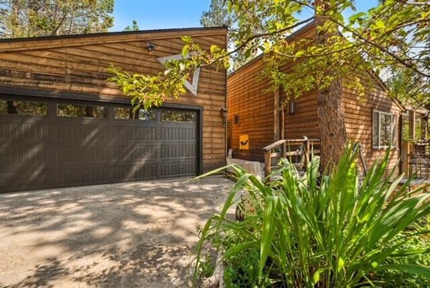 This property is not just a residence; it's a unique retreat & experience waiting to be shared. Step into this exceptional home and incredibly comfortable living space. In addition to the main home, it offers an additional  detached multipurposed artist studio/ ADU as well as an attached sunroom that can be used as a greenhouse or yoga room. Easy access to local attractions, parks, & dining, welcoming the best of Bend living. This home has a unique design, both inside and out, full of thoughtfully custom crafted artistic flair that brings a welcoming ambiance. A spacious, light-filled layout perfect for entertaining or enjoying quiet moments. The gourmet kitchen is equipped with modern appliances, sleek countertops, and a pass-through window and bar counter opens to the outdoor living spaces. Fully ''remodeled'' custom guest bathroom, new windows, as well as new features in the kitchen. Primary suite has its own private patio creating its own unique space by the pond and water feature