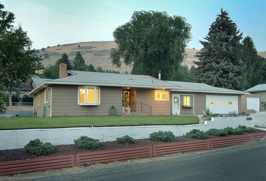 Beautifully landscaped home, in the suburbs, boasts 3 bedrooms, 2 baths & a spacious 1559 sq. ft. Single level living with walk-in shower. All appliances, plus additional freezer, are included. New kitchen sink with instant hot water. Large laundry room has huge pantry. Third bedroom has its own entrance & could also be a bonus, hobby or rec room. Lots of storage space & walk-in closets. Over-sized 2 car garage. Additional 32 x 12 detached shop/garage with 220. Generator hook-up in home. Septic system is only 6 years old. This lovely home is located in a desirable & peaceful neighborhood.