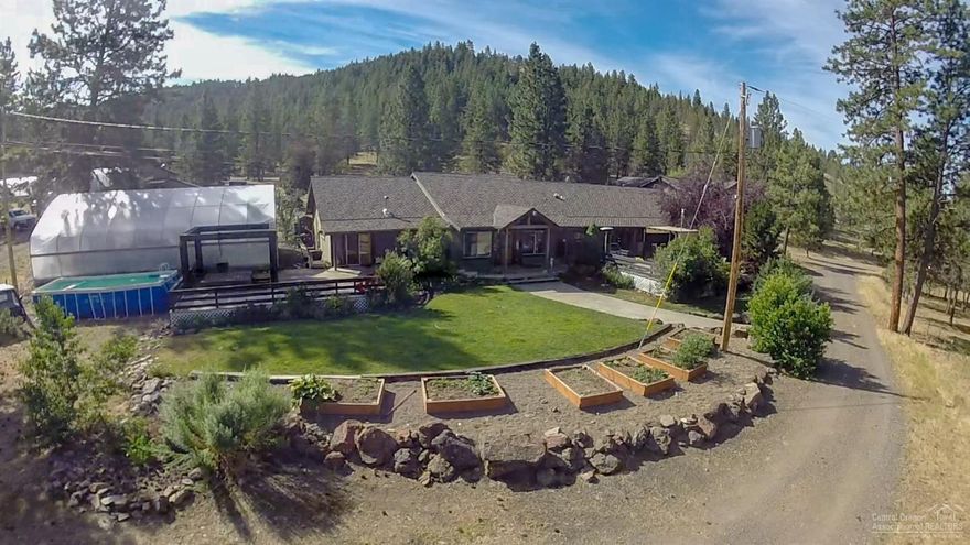 Beautiful custom home in the pines, McKay Creek running through it, the Sawtel Ranch sits on over 200 ac w/57.3 ac. of irrigation, 60x40 shop, 48x32 shop, 60x30 barn, 5 stalls, tack room, chicken coop, dog kennel, large storage room & bathroom. 4 large greenhouses & loaf stalls/hay shed. Home features 2 master suites w/fireplaces, a guest bedroom w/fireplace, huge guest quarters w/full bath above a 3 car garage, office & library, open kitchen/great room, sunken living room, vaulted wood ceilings.