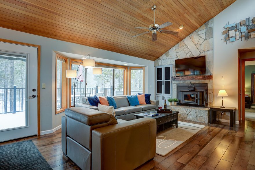 20 Lassen Lane is a beautifully updated home located on a corner lot w/ huge common area to the rear & side in the desirable north end of Sunriver. This home enjoys panoramic views of the pine forest out back, & vaulted clearstory windows flood the great room w/ natural light. Floor-to-ceiling stone and woodburning stove insert create a warm, inviting space. Kitchen features granite counters w/ an eating bar & hardwood floors spanning through the great room. The large upper deck space is perfect for outdoor living at its best.  The upper-level master suite offers a spa-like experience w/ dual vanities, heated tile floor & tiled shower. A 2nd Jr. Suite on the lower-level w/ a Jack 'n Jill bath configuration accessible to guest staying in the 3rd bedroom or those hanging out in the separate living room area (or 4th sleeping area) on the lower floor. The lower-level deck has a privacy wall & is wired for a hot tub. A fabulous floor plan for families and guests. SHARC Paid.