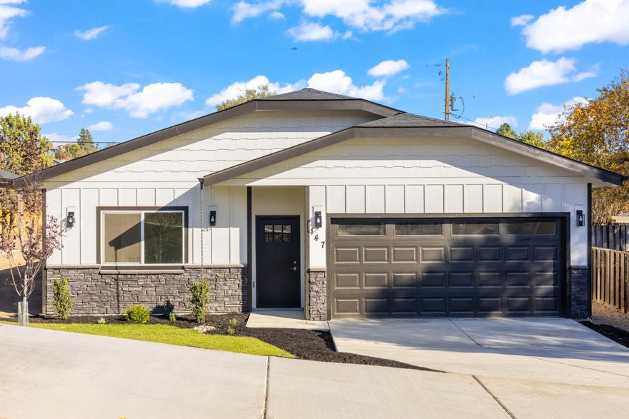 Step inside this beautifully designed 3-bed, 3-bath custom home offering 1,858 sq ft of thoughtful craftsmanship and modern comfort. Featuring two spacious primary suites with tray ceilings, walk-in closets, and well-appointed baths - the main with a walk-in shower and dual sinks. The open-concept layout showcases luxury vinyl plank flooring, 9-foot ceilings, and a stunning kitchen with floor-to-ceiling cabinetry, quartz counters, soft-close drawers, a walk-in pantry, and a large island perfect for gatherings. Enjoy seamless indoor-outdoor living with sliding doors that lead to an expansive covered patio and fully landscaped yard. With central A/C, forced-air heating, a finished double garage, and convenient alley access - this home delivers quality, comfort, and exceptional value in every detail.