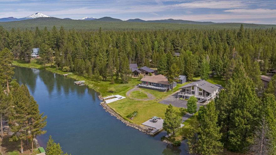 Experience the extraordinary allure of this exceptional, one-of-a-kind riverside residence on the majestic Big Deschutes River with breathtaking views. Immerse yourself in the luxury of this established vacation rental which features a private boat slip and dock, cozy fire pit, complemented by a spacious upper deck and a lower paver patio area complete with a hot tub and sauna, offering the epitome of relaxation. This two-story home has undergone meticulous updates, boasting five bedrooms and three bathrooms, with the river gracefully visible from nearly every room. The vaulted living room showcases a knotty pine ceiling, fireplace, and a magnificent wall of windows framing the river panorama. Spanning over 3500 sq. ft., this residence provides ample living space.  Prepare to be captivated—this is an opportunity not to be missed.