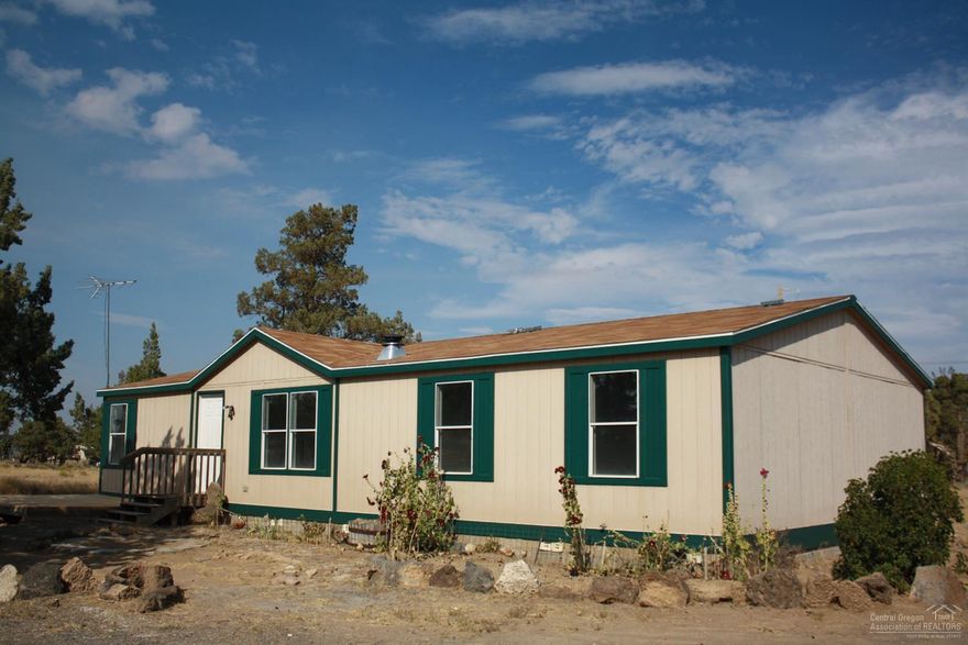 Peace and quiet with beautiful Cascade Mountain views on 4.67 acres. New laminate floors and interior paint. Very clean 4 bedroom and 2 baths. Property is partially fenced, has a large circular driveway, carport and storage building. Plenty of room to build a shop. Bring your animals and all your toys!! All this and only minutes from town!