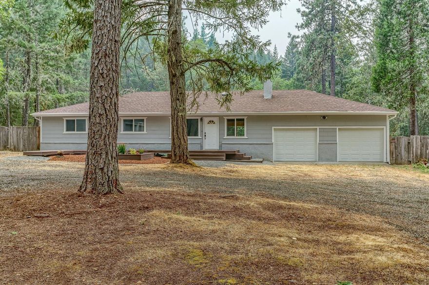 Beautifully remodeled country home on 2.5 level, wooded acres. Featuring a spacious 3 bedroom, 2 bath main home with 2,128 sf. Open floor plan has large great room, stacked stone fireplace and plank flooring throughout. The cook will love this updated kitchen featuring Alder custom cabinetry with soft-close hinges and glides, leather granite counter tops, stone back splash, new SS appliances and center island. Dining area has slider to a new 300 sf deck; great for entertaining family and friends. Luxurious master suite with dual vessel sinks, Alder cabinets, sliding barn door entry to bath with tile shower with seamless glass. Large bedrooms plus bonus room that would be a great office/den. Two car attached garage, new doors and opener. Cute 1 bedroom, 1 bath guest house w/ attached 2 car garage. RV garage is 650 sf and separate 22x30 workshop. Close to Fish Hatchery Park and all your outdoor adventures. Don't miss out on this great home and all it has to offer. Check out Virtual Tour