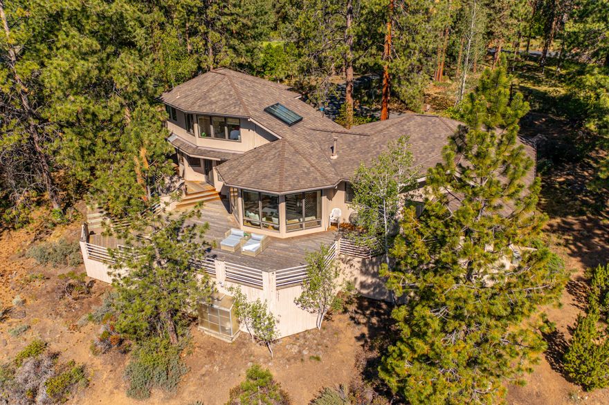 Homes like this are the reason why Bend has become a mecca for the Outdoor enthusiast & you'll quickly understand why when visiting the lovely neighborhood of Sunrise Village, on Bend's Westside. This quality built home is on a .83 acre of land right on the Deschutes River & min from Downtown! From this 4BD, 3BA home all you hear & see is nature; w/relaxing sounds of the river & wind in the pines. Home offers tremendous natural light & an open floor plan w/dual primary suites, an updated kitchen, expansive decking, an oversized 930 SF garage & plenty of storage throughout. Addt'l features incl. granite slab counters, SS appl., extensive hardwood flooring, wood doors & trim, vaulted ceilings & custom built ins. Expansive primary suite on the main level offers gorgeous views, large walk-in closet, soaker tub & tile shower. Upstairs offers another spacious primary suite w/ lovely views, walk-in closet & tile shower. Fun HOA amenities incl pool, hot tub, clubhouse, tennis courts & trails.