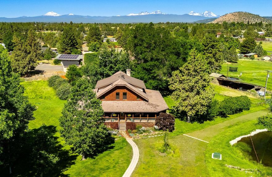 Discover a special piece of Bend history on 2.42 acres with .9 acres of senior COID water rights. Originally homesteaded in 1911, this thoughtfully restored property features the fully updated 1929 stone farmhouse and a charming, modernized original cabin. The 4-bed, 3.5-bath main home blends timeless character with high-quality finishes, updated systems, and two primary suites. A spacious 5-bay garage with workshop adds flexibility, while the wraparound covered deck overlooks the orchard, irrigation pond, and open landscape. Recent price adjustment reflects the decision to separately list the adjoining pasture, which is its own legal lot—see 61855 Dobbin Rd. Buyers benefit from more favorable pricing when purchasing both together. A rare opportunity to own a private retreat, small farm, or legacy homestead just minutes from town. For more Info see Recent Podcast here : bit.ly/3Y4orzI