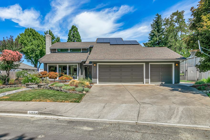 Welcome to one of the premier properties on the Rogue Valley Country Club—3255 Miller Court. Perfectly positioned at the top of the 7th tee box, this beautifully renovated home offers refined, modern golf course living. Soaring ceilings and abundant natural light highlight the open-concept, loft-style layout featuring a chef's kitchen with induction stove-top, double ovens, granite counters, oversized island, wet bar, and ample cabinetry. Through oversized sliders, a true poolside retreat awaits with waterfall, outdoor kitchen, hot tub, fire pit, full poolside bath, outdoor shower, and golf cart garage. The private primary suite includes a spa-like bath with walk-in tile shower, dual vanities, and custom closet. Upstairs offers two additional bedrooms, full bath, and flexible office/loft space for hobbies or guests. Three-car garage plus side yard with raised garden beds.