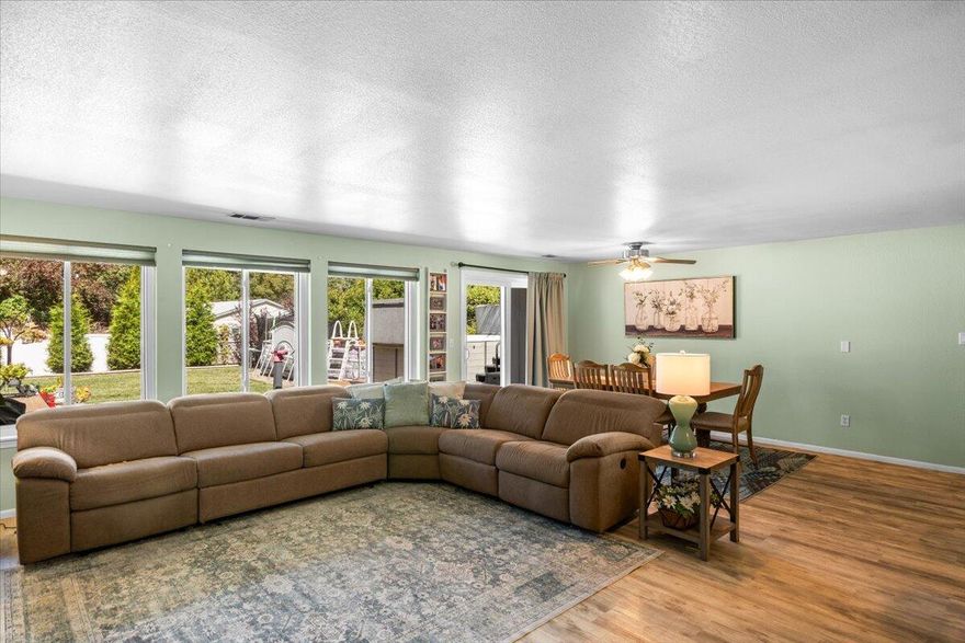 Charming Home in Tranquil Cul-de-Sac! Nestled in a peaceful neighborhood with only seven homes, nearby popular hiking trails at Cathedral hills, and has direct access to the Grants Pass Country Club golf course. Enjoy a single-level split plan featuring a spacious master bedroom with an ensuite bathroom, along with two additional average-sized rooms and a convenient shower tub combo bathroom. The living room serves as a stunning focal point with high ceilings, complemented by a bright open kitchen with brand new windows that provide lovely views of the backyard. Step outside to discover your private oasis, complete with a BUILT-IN GAZEBO and a NEWER LAP SPA, all surrounded by durable vinyl fencing. This fantastic location combines tranquility with easy access to recreation. Don't miss your chance to make this beautiful home yours! HOME IS ON A SHARED WELL. NO WATER BILL!!  THE HEAT PUMP IS ONLY 2 YEARS OLD...Home is Sold As Is