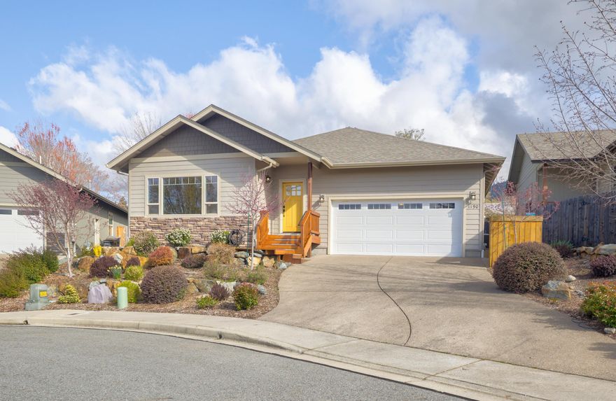 Welcome to this meticulous 3-bed, 2-bath gem, nestled in a quiet cul-de-sac in Northeast Grants Pass. Built in 2017, a perfect blend of modern luxury and serene, nature-inspired beauty. Professionally landscaped grounds feature elegant Japanese maple trees, adding a touch of tranquility to the yards. Garden beds and trellis netting are ready for the Spring garden, and the covered back porch is calling for a BBQ!  Step inside to a light-filled, open living space, where large windows frame long-range mountain views, bringing the outdoors in. Engineered hardwood floors throughout, offer both style & durability. The spacious kitchen is a chef's dream, complete with granite countertops, roll outs, and large island. The living room and dining area are bathed in natural light, creating a warm and inviting atmosphere. The primary bedroom includes an efficient en-suite w/ step in shower and walk in closet. This one is calling you Home!