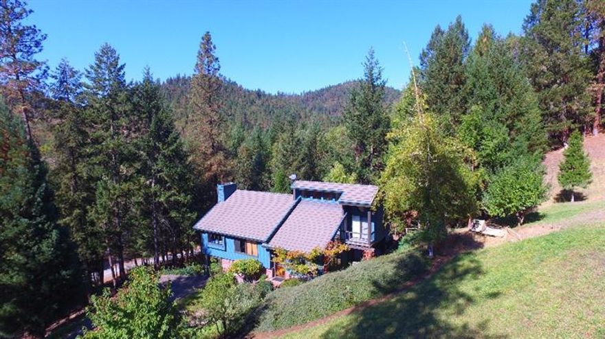 You're in for a treat with this Oregon property! Lived in for 27 years and time to pass on to someone to love it as much as they have. Now available is this bi-level home nestled in trees with one of the biggest indoor shops you can have. 6,000 sq feet of space with 18 ft ceilings, heated, 3 pull up doors, air compressor system, water, room for RV's, semi's, equipment, repairs or whatever it truly is a dream shop! Parking at the shop and it's separate from where the house is. The house is nestled on hill with wildlife all around you! Quarter mile of creek frontage, close to Medford and Grants Pass and only a few miles to the Rogue River. You have grand views of the mountains with ATV and horse trails around you. Open floor plan with vaulted ceilings. Must see to appreciate as this is not a drive by. Oregon serenity awaits you! All information deemed accurate but not guaranteed and subject to change at any time. Buyer to perform all their own due diligence.