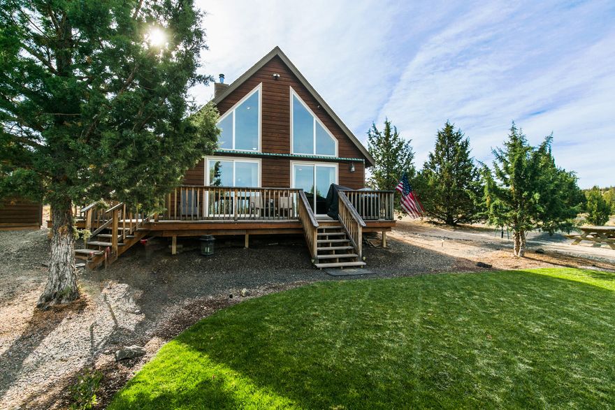 Secluded 1.81 acre parcel w/gorgeous chalet style cabin & direct access to over 75,000 acres of Millican BLM Land - great trail riding for horses and ATVs, you can even ride to the Prineville Reservoir! Perfect place for privacy & Central Oregon living, located in quiet SE Prineville! Vaulted living area features floor to ceiling windows for an abundance of natural light throughout the entire home. Open concept living w/ wood burning fireplace w/ tile surround, plenty of cabinetry & counter space in the kitchen, laminate flooring throughout main level living area, tiled bathrooms, carpeted bedrooms & loft area! Covered wood shed, storage buildings, detached garage for parking, RV/Boat parking w/ RV hookups. Enjoy Central Oregon sunsets around the firepit or from the deck. Huge shop w/ parking! Don't miss this one!