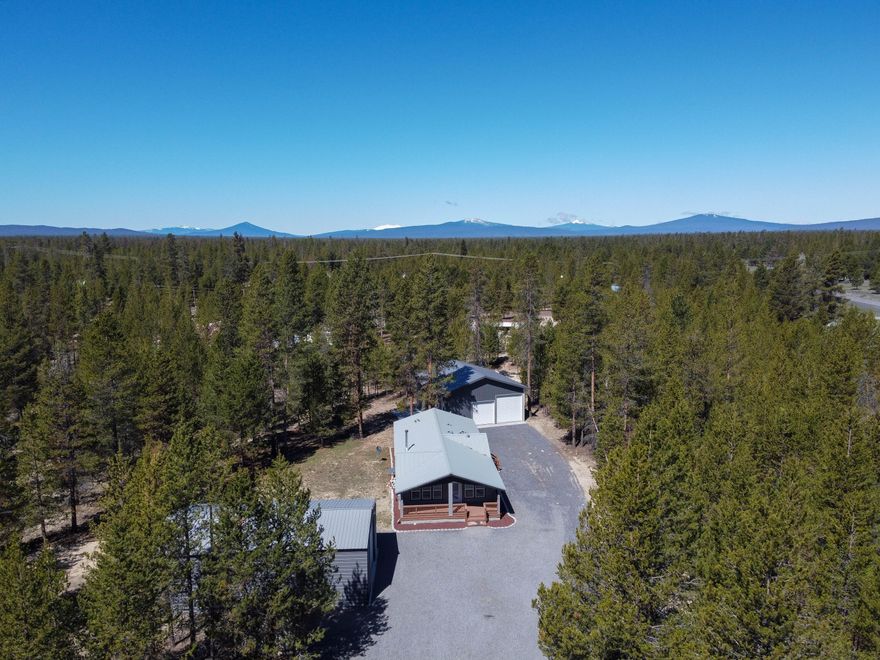 This is a wonderful opportunity to own a beautiful and well kept home in a great location! This 3 bedroom, 2 bathroom home built in 2017 has a 1,512 square foot, open concept floor plan, certified wood stove for the cold winter months, soaking tub in primary bathroom and a spacious mudroom/laundry room. Enjoy the feeling of privacy on this lot in Sun Forest Estates with its tidy, low maintenance yard alongside the large covered front porch, perfect to enjoy the Central Oregon summer evenings. This property has an enclosed 24x45 Metal Storage Building with 14 ft center and 12 ft sides, and a 36x36 Two Bay Shop with concrete floor - plenty of room for parking your cars and toys. RV Parking and Septic Dump are also located on the property along with a paved patio area and small storage shed. Don't let an opportunity like this pass you by!