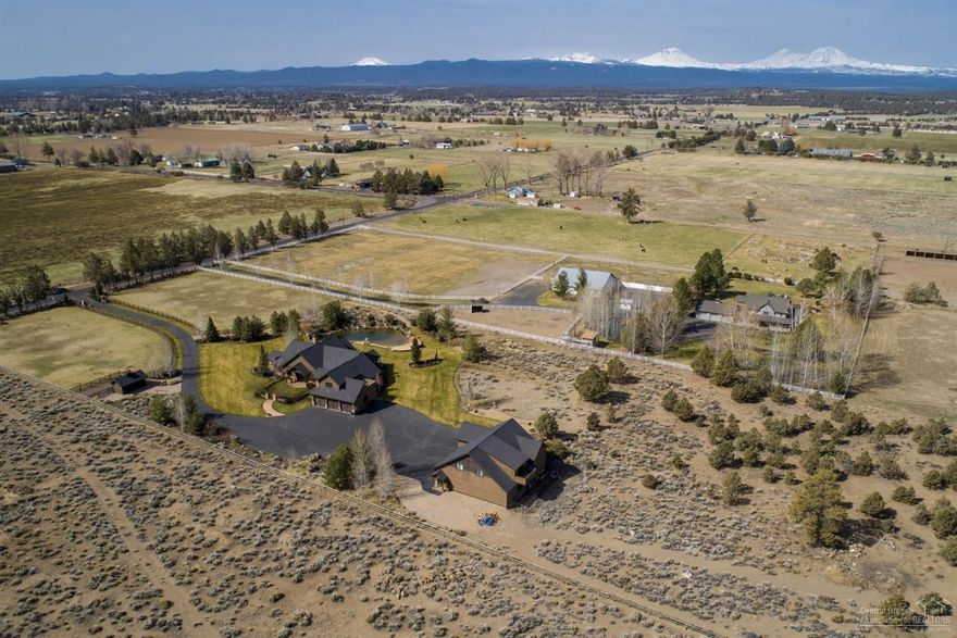 Elegant style and gracious living await! Sophisticated Pacific NW masterpiece with sweeping Cascade Mountain and Cline Butte views. Nestled in a peaceful setting, this captivating home offers tranquil country living with impressive amenities for the discriminating buyer. Gated 9.28 acres, 2 fully-fenced pastures, 1.48 acres of irrigation, swimming pond with sandy beach, 3-bay shop with 912 sq. ft. guest quarters, and direct access to BLM lands, this estate celebrates the Central Oregon lifestyle!