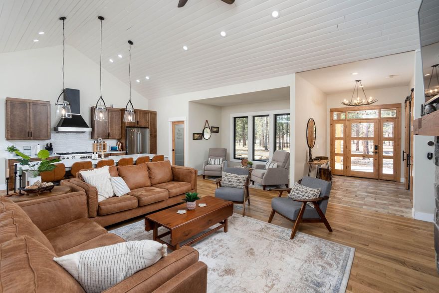 Picture perfect new construction 2496 SF hm situated on 8.64 acres w/ 2400 SF RV/shop. Fabulous finishes make this your dream hm situated on 8.64 acres w/ 2400 SF RV/shop. Fabulous finishes make this your dream hm nestled amongst the pines, fully fenced & gated lot.  Great rm has 42'' floor to ceiling stone fireplace w/ blower, vaulted ceilings, gleaming hardwood floors, ceiling fans & folding sliding doors which open to your massive covered outdoor entertaining space complete w/ spa.  Gourmet kitchen has center island, quartz counters, high-end commercial quality appliances, walk-in pantry, decorator pendants& wonderful details.  Primary bd is on main level complete w/ walk-in closet, dual vanities, soaking tub, tiled shower & door leading to back patio.  Bonus rm is upstairs w/ 1/2 bath.  You'll also find a 20'x30' ADU w/kitchen, bathroom & laundry.  Come visit this Sanctuary!