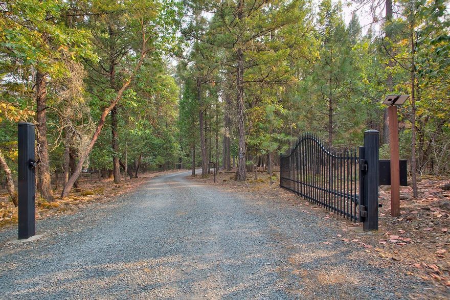 Lightly wooded retreat. Four separate attached garages with work shop area and wine cellar. The home has the character and charm of your own private paradise. Three level, custom built home. The main floor has an open floor plan, master bedroom with large walk in closet, spacious bath with vanity and jetted tub, and an office, which can easily be used as a bedroom. Upper level has large open loft area, a sewing room, full bath and large bedroom with its own balcony. Kitchen and baths have tile flooring and the remainder of the house has teak wood floors. Over-sized windows throughout to let nature in. Storage galore, including well designed cabinetry in spacious kitchen. Plus, RV parking with dump, two covered parking areas, circular drive, and gated entry.