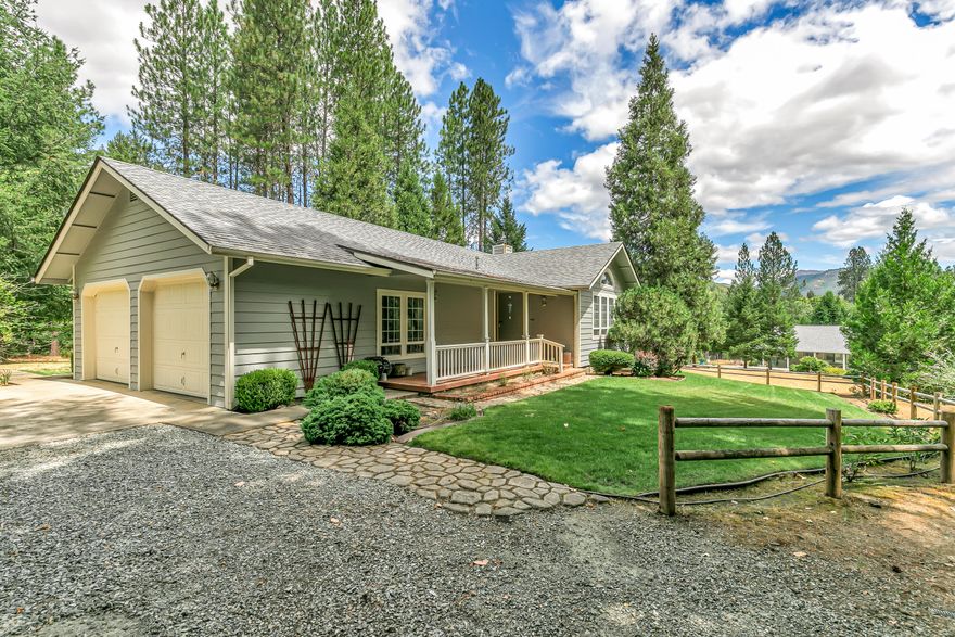 This inviting 3 bedroom 2 bath home offers 1,588 sqft of comfortable living space set on 2.17 peaceful acres. A vaulted ceiling and cozy wood-burning fireplace create a warm, open feel in the living room. The kitchen has classic tile countertops, a dedicated coffee bar, and sliding doors that open to a spacious deck. This outdoor space is also accessible from the primary bedroom, perfect for relaxing or entertaining. The primary suite includes a walk-in closet and tile shower/tub combo. Plenty of parking with an oversized 2 car garage, 864 sqft detached 2 car garage/shop, and space for an RV or boat. The shop features a half bath, breaker box with 220v outlet, and brand-new roof with skylights. Combining functional amenities with plenty of room to grow, this property is the ideal place to create the home and lifestyle you've always envisioned!