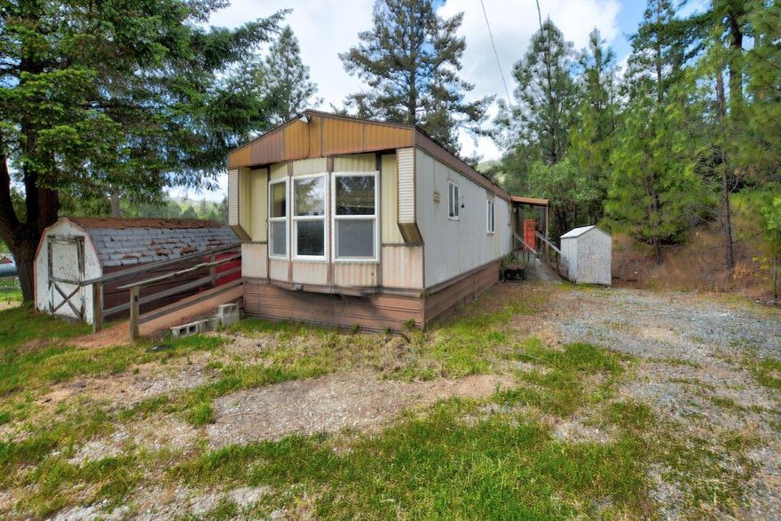 Beautiful setting on 5.68 acres, amongst the hardwood and conifer trees that grace the property and meadows with all infrastructure in place, including well, septic, power, roads and homesite.  Enjoy the wildlife, peace and tranquility that this property offers while being only a couple miles from the I5 exit.  2 Bedroom, 1 bath single wide is of little value, but with some TLC it could be livable.  Property sold as-is, buyer to do their own due diligence on all aspects of the property.