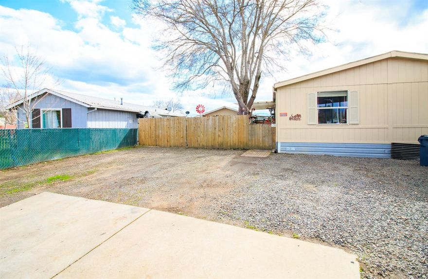 Lovely, well maintained home in the middle of a cul-de-sac. Vaulted ceilings in the large living room with a second living area off of the kitchen. Island cutting board in the kitchen with plenty of storage. Large master suite and master bath. Room for a second fridge or freezer in the laundry room. Private front porch. Well maintained yard with room for raised bed gardening. Garage is only about 3 years old. Hot tub enclosure on the side of the garage for extra privacy. Lots of parking for cars, boats, RV's, or your other toys, some of the parkin is behind a lockable gate! Home was placed on a new foundation. Walking distance to the store. Don't delay, this won't last long. Home is twice moved. Buyer to do own due diligence with their lender regarding financing.