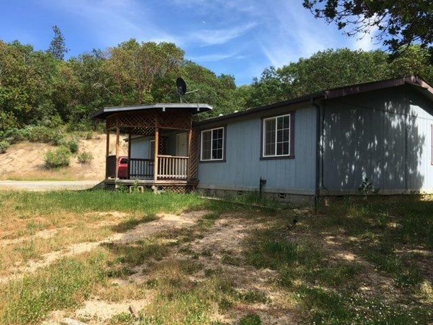 Three Bedroom two bath 1995 Doublewide Manufactured home. Master bedroom with master bath. Good separation of space. Carpet in living rooms and bedrooms. Vinyl flooring in balance of rooms. 3.58 hillside acres. About half acre flat around home, balance of property steep. Back porch is only a concrete block foundation. Caution when viewing. Some minor deterioration with siding. Well log when drilled in April of 1994 shows 20 gpm. Private gravel driveway to house.