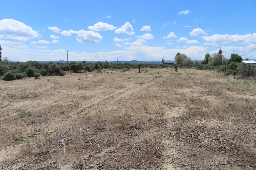 This attractive third-acre corner lot boasts a convenient location with a paved road alongside it. The property has been partially cleared, providing a clean canvas for your ideal living space. Embrace the natural beauty and unique offerings of the high desert environment. Within close proximity, you'll find a selection of amenities including grocery stores, and a Dollar General, making everyday shopping a breeze. Hardware stores, a Credit Union, and emergency services are also available locally. Take advantage of this opportunity to construct your dream home or explore the option of having a new home placed on this promising property.