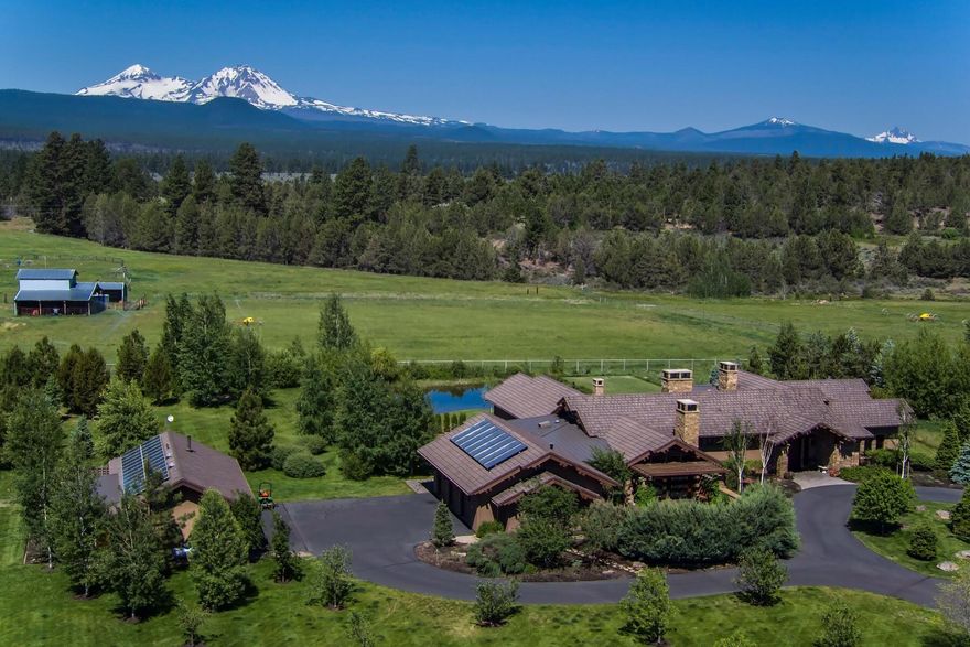 Cascade Mountain Views from this spectacular Tumalo estate situated in the middle of 11 deeded acres. The Contemporary Home features: 5614 sf with 4 bedrooms, 4.5 baths, single level, gourmet kitchen, formal dining, living room w/ fireplace, family room w/fireplace, office, bonus room with built in bar and pool table, in ground spa, utility room, solar and attached 3 car garage with built in cabinets. Additional detached 2 car garage with office/flex room, solarium/green house solar. Wonderful outdoor living with patios, water features, fireplace, outdoor kitchen, pizza oven, fenced garden, orchard and pond. Property is fenced, gated, includes 10 acres water rights with updated sprinkler system and green pastures. This stunning home is located in the desirable West Tumalo area and minutes from the Tumalo Reservoir and National Forest for any recreational lifestyle!