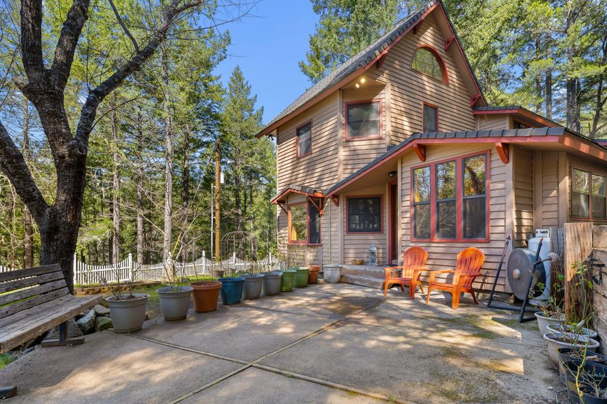 Escape to Selma to your own woodland retreat in the beautiful Illinois Valley.  There you will find 2-story, 2186 sq ft custom home is nestled among majestic trees. This eye-catching home offers vaulted ceilings, incredible wood work, a spacious kitchen with skylights and a butlers pantry, hardwoods floors, and panoramic windows. The main house features an open concept living room with a cozy wood stove, two large bedrooms and two bathrooms. The bathroom has a walk-in shower and a soaking tub with a view. Off of the front entry is an enclosed porch that is ideal for relaxing in the evening. The detached office/guest suite has its own private deck next to a seasonal creek. This charming space has several rooms that offer versatility and comfort for guests or remote work. The 5.24 acre property also includes a detached 2-car garage, work shop, chicken coop, RV parking with elec hookup and an area all ready for a hot tub. *Seller's loan is an assumable FHA to qualified Buyers.