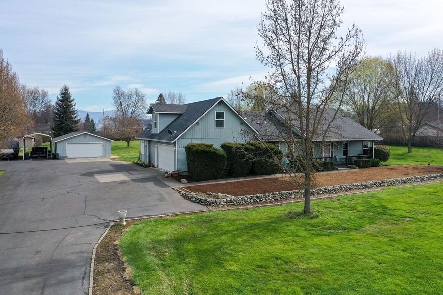 This beautiful home boasts over 2800 sq.ft. and sits on 2 irrigated acres between Medford and Jacksonville. With 3 bedrooms and 2.5 bathrooms, all on the main level, there is also a huge bonus room on the second level of the home that has unlimited potential. Huge kitchen with plenty of cabinet and counter space and a breakfast bar. Large living room as well as a formal dining room. Upstairs can easily become two bedrooms, office or second family room. The primary downstairs has double vanity, walk in closet, jetted tub, and shower. Outside you will find 2 flat acres of irrigated lawn. There is a separate shop/garage that also has unlimited potential. This a very rare property and a must tour.