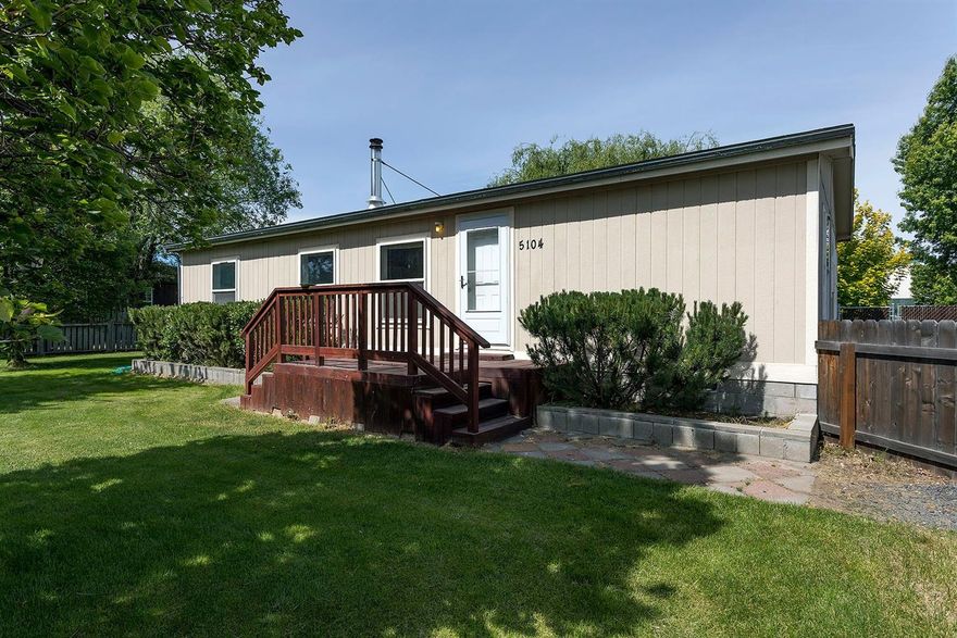Park-like setting in the suburbs with covered back deck that looks out over a large .59 acre yard; mature trees including 10 fruit trees, berries, designated garden spot. A beautiful willow tree shades the deck. Detached oversize 2 car garage-30x32 is wired for 220 also includes a workbench and shelving. Lots of graveled parking area, including RV parking and power hook up. Ample protection for the toys, in the storage shed off the garage with power and lights. Close to schools. Master suite includes a walk-in-closet. Handy laundry room/mudroom area off the back deck. Open main living area with laundry. Open kitchen with large pantry. Certified wood burning stove is decorative as well as practical in the cooler months. Other features: drive through gate to the back yard, fully fenced yards, in-ground sprinklers in the front yard, auto garage door openers. KID irrigation with new 3hp pump. Upgrades include new bedroom carpets, new kitchen sink, some blinds, new storm door and tie downs.