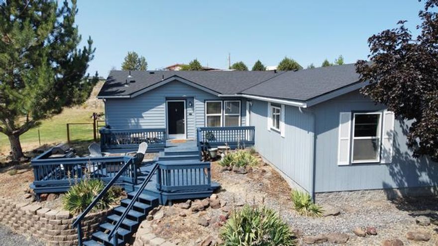 This little gem is in Crooked River Ranch has a great layout and is perfectly situated on a 1.16 acre lot.  The primary bedroom with bathroom has dual sinks and a soaking tub and separate shower.  It is on the opposite end of the home from the other two bedrooms, providing privacy.  The living room, dining room, and kitchen layout has a semi-open concept allowing a nice flow between the main areas of the home.  The kitchen features granite countertops and stainless steel appliances.  The home also has A/C, a laundry room that includes front loading washer and dryer with upper cabinet space, and both of the bathrooms have quartz countertops with under-mount sinks.  The garage is an oversized 2 car garage, with ample space for work areas or storage.  There are front and back decks and the property has great views of the Cascades.  There is a fenced yard with sprinkler system, and plenty of room for kids to play, animals to roam, or a shop to be added in the future.