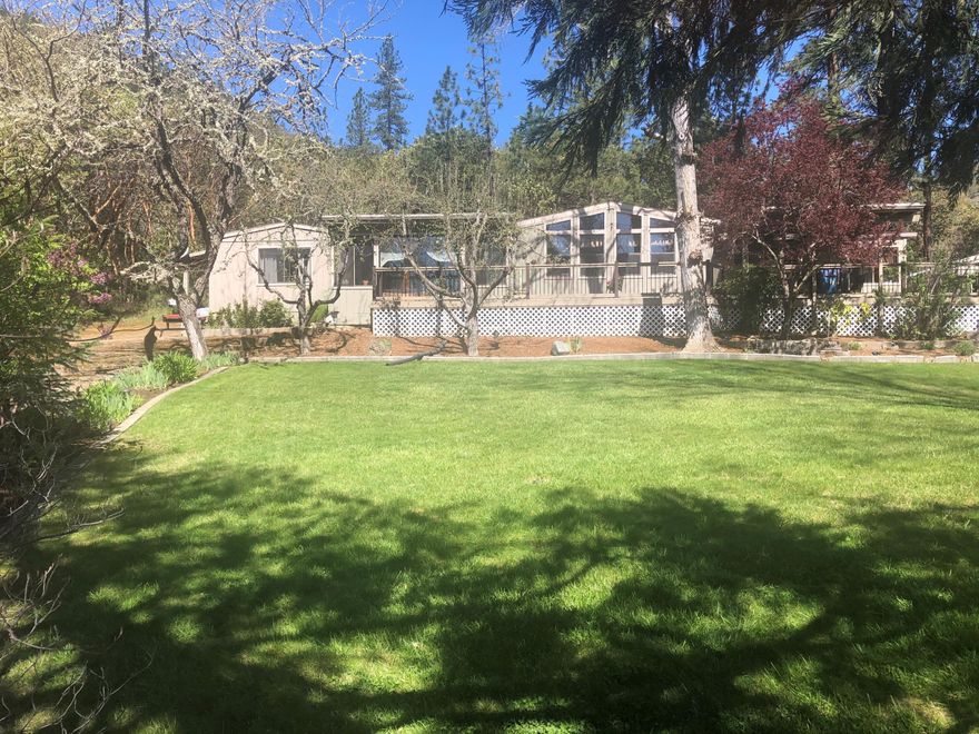 A home with view & privacy in a peaceful, beautifully landscaped property. Has 3 bedrooms & 2 bath with a office This has a amazing front deck over looking the property & mountain area also a back deck surrounded by trees. A pasture all fenced & ready for your animals to be in with a barn 720 square feet. 
There is a fenced garden area also and a landscaped lawn. Inside the home you have a view of the property from the living room. A hot tub, a new roof was done in 2014, Hot water heater in 2020, septic was pumped in 2022, new Heat pump 2019. Good producing well a new pump installed in 2018. There is a hobby room off of the garage also. A great country property  and and only 8 mins. from down town Rogue river. Its a MUST SEE!