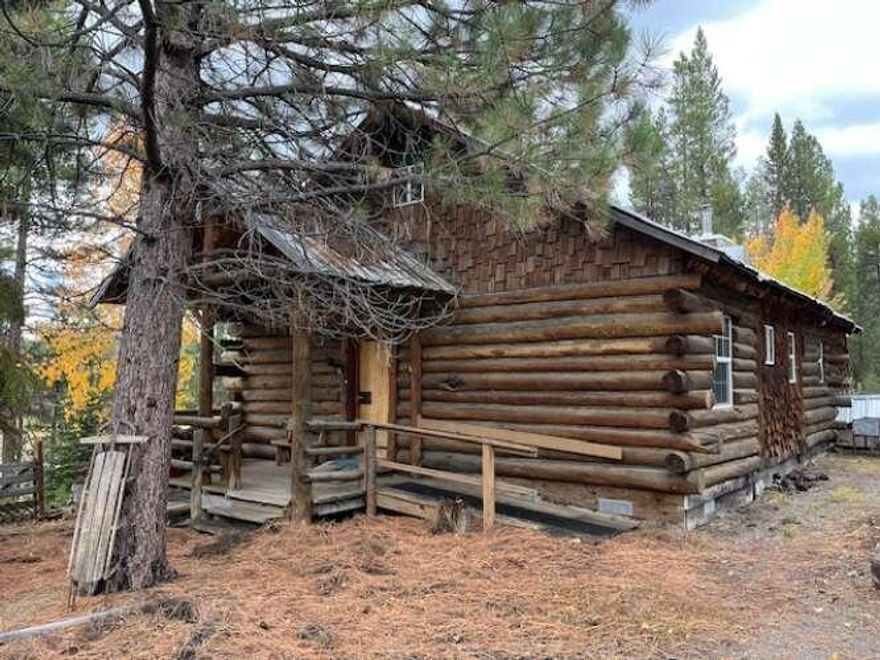 Secluded 2 Bed, 1.5 Bath Cabin on 4.86 acres with River frontage. The home is 700sq. ft. with many handcrafted features from lumber milled from the property. Landscape is mostly variety of Lodgepole and Ponderosa Pine Trees. Post and Pier foundation. The home has been empty for several years and will require attention in the plumbing, electrical box and balcony.