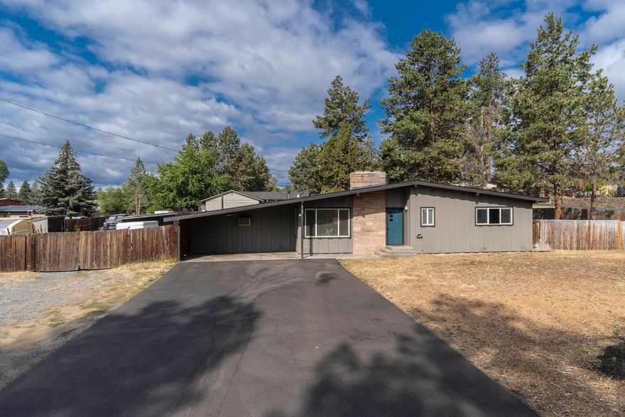 Immaculate sun filled newly renovated one level home on huge 1/2 acre fenced yard. Close to shopping, restaurants and the Old Mill District.  Move right in to this beautiful home with new kitchen, Luxury Vinyl Plank (LVP) floors, new windows, exterior doors, interior and exterior paint.  Cozy up and relax in front of the floor to ceiling natural stone fireplace with new Pellet Stove. Two spacious bedrooms and bathroom with double vanity and large tub with tile surround and ceramic tiled floor. Large Bonus room can be used as a 3rd bedroom, media room or office. Entertain outside under the covered patio or gather around the fire pit to roast marshmallows and stargaze.  Plenty of space for greenhouse, gardening and all your Bend toys (Boat, RV, trailer, camper etc.). Shop with electricity can be a Man Cave, Studio or office. Generous laundry/storage room. Vacation STR license available.