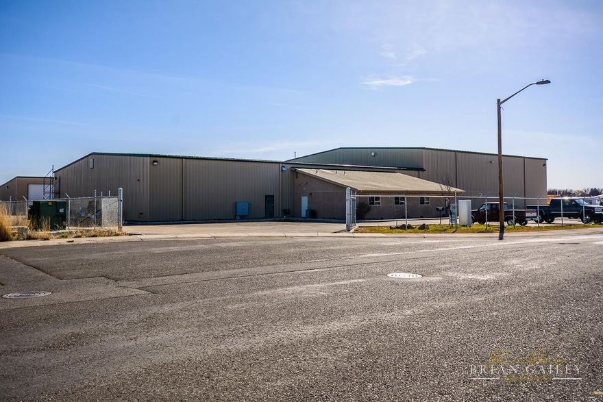 5-Year Triple Net lease in place (through 2022) with annual escalation. Long-term manufacturing tenant in the airport industrial park. Industrial warehouse & office built in 2010 on 4.97 acres next to regional airport. A total of 37,840 Sq.Ft. per County records and comprised of: 21, 900 sq.ft. in first steel warehouse; 14,500 sq.ft. in 2nd steel warehouse; 1400 sq.ft. of nicely finished office space. Clear span buildings with 600 Amp/480 electric service. Heated throughout. Overhead doors in each warehouse and framed for additional. Steel frame I-beams for an overhead crane. Complete fire suppression throughout. Reinforced heavy-duty concrete flooring. Paved parking lot (approx. 17,500 sq.ft of paved parking). Complete Cyclone perimeter fencing. Room for additional buildings or parking. Office Space: 4 private offices, conference room, 2 bathrooms, kitchenette, stained concrete floors - all nicely finished. Warehouses are 23' tall at sides of buildings. A/C in office area only.