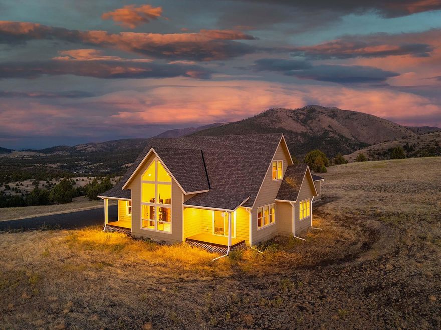 Experience peaceful living on 40 acres above John Day with sweeping 360° views from this beautifully crafted 3 bed, 3 bath, 2,259 sq ft custom home. Built in 2018 with high-end finishes throughout. The home showcases vaulted/ 9' ceilings, striking floor to ceiling windows, & solid oak flooring. Spacious main level features gourmet kitchen w/granite counters, Lg prep Island, eating bar, pantry, & walnut cabinetry. The primary suite includes a walk-in closet, claw foot tub, & walk-in shower. Also on main floor: second bedroom, additional bath, laundry room, & access to a covered Trex deck & paver patio—perfect for entertaining. Upstairs offers a large loft/office, third bedroom, full bath, bonus storage & a sleeping/play area tucked in the stairway. Property includes a finished insulated & heated 26x36 shop, private well, minimal animal setup, partial fencing. Potential second home site adds future flexibility. A blend of luxury, privacy, and scenic beauty!