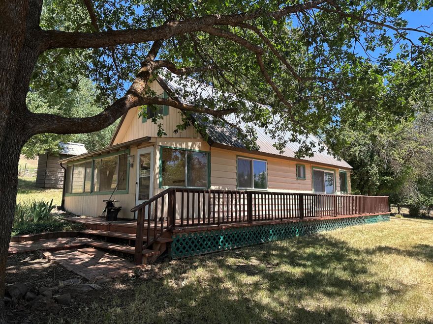 This property has potential!! 3 bedroom 1 bath home on over 2 acres in the desirable Keno area. It needs some TLC but possibilities are endless. Enter the enclosed front porch into the living space and kitchen. Bathroom and 1 bedroom on main floor with slider out to deck.  Off the kitchen is another enclosed porch/ mud room. Upstairs has 2 bedrooms with storage closet between them. Property is partially fenced with garage, two storage sheds/containers, nice trees and other flowers.  Plenty of room to park and store extra toys! Home is being sold as is. 480 Sq Ft is Finished Attic and home is 776 Sq Ft.